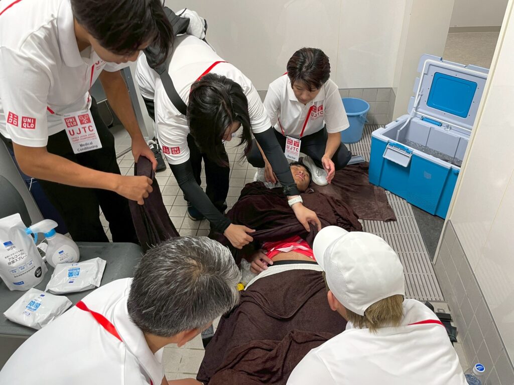 ユニクロ全日本ジュニアテニス選手権2025(有明)でのスポーツトレーナー活動記録。救急救護、熱中症の救急搬送対応、WBGTに基づくヒートルール運用、ドクター連携、トレーナールームのケアとコンディショニングを、確かなガイドラインに沿って分かりやすくレポート。春日部・埼玉でのサポートもご相談ください。